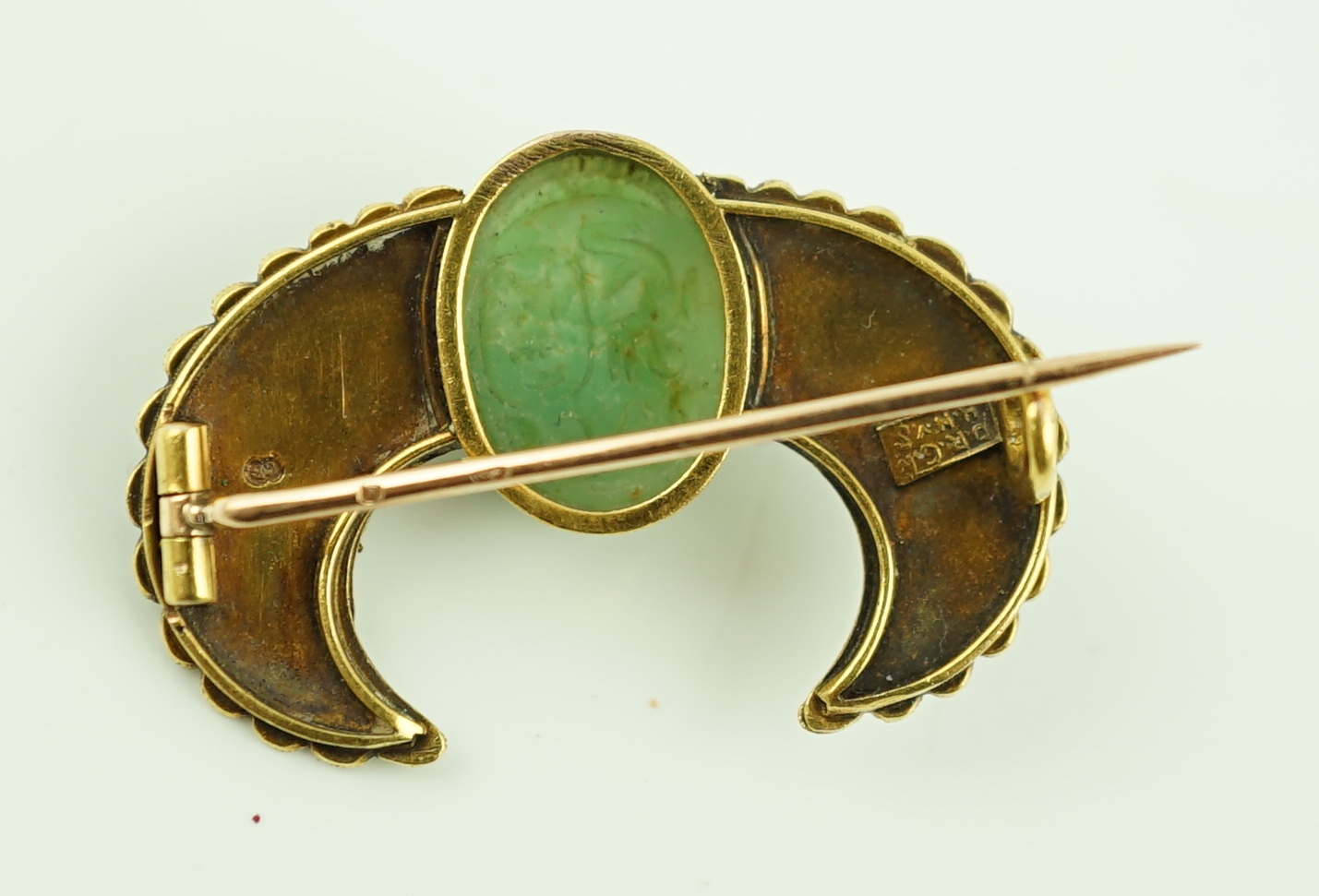 An early 20th century Carl Bacher Viennese Egyptian Revival gold (tests as 14k), diamond and three colour enamel set winged green hardstone scarab brooch, 31mm